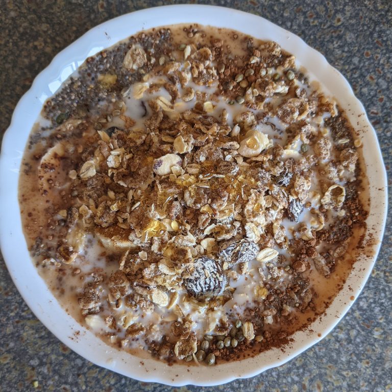 Eating a Healthy Breakfast with Muesli, Chia Seeds, Sunflower Seeds, Pumpkin Seeds, Hemp Seeds, Raw Cacao and Cinnamon