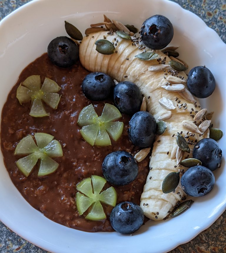 Chocolate Chai Oats Breakfast with Blueberry, Banana, Grapes, Chia Seeds, Sunflower Seeds, Pumpkin Seeds and Honey