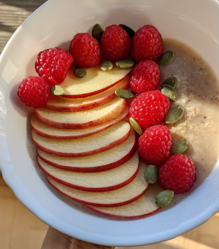 Banana Cinnamon Oatmeal Breakfast with Apple, Raspberries and Pumpkin Seeds
